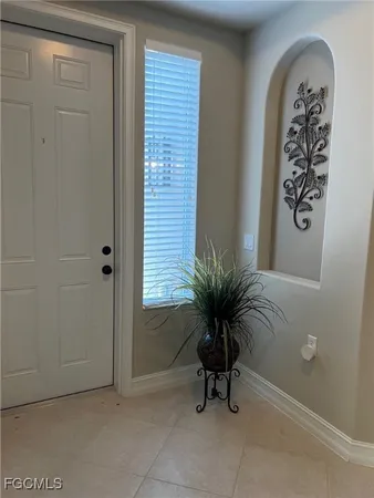 a view of a room with window and potted plant