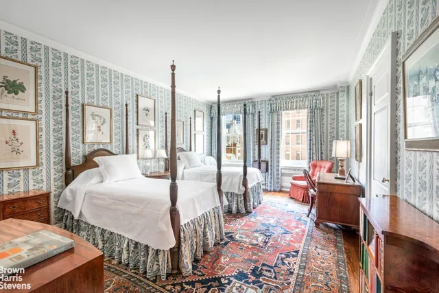 a large bedroom with two beds and large windows