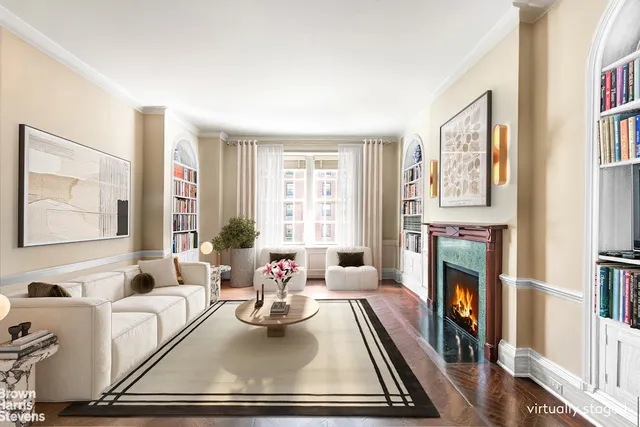 a living room with furniture fireplace and a large window