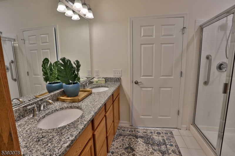 18 Barnett Road Flemington, NJ 08822 - Photo 16 of 25 a bathroom with a granite countertop sink a mirror and a shower
