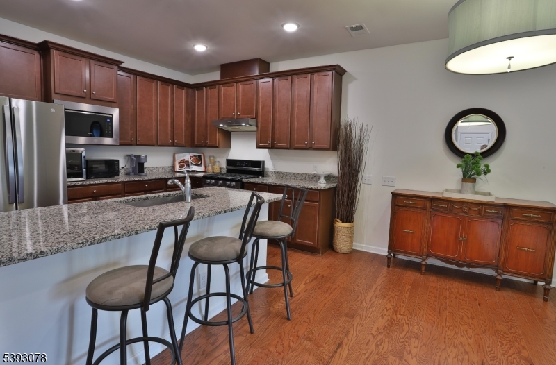 18 Barnett Road Flemington, NJ 08822 - Photo 8 of 25 a kitchen with granite countertop a table chairs stove a refrigerator and cabinets
