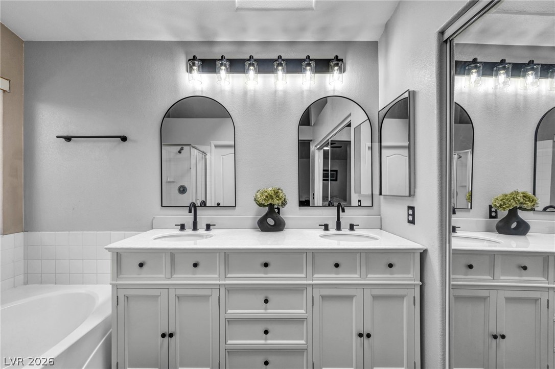 2132 Polynesia Circle Henderson, NV 89074 - Photo 14 of 25 Recently refreshed with new vanity, lighting, and refinished tub