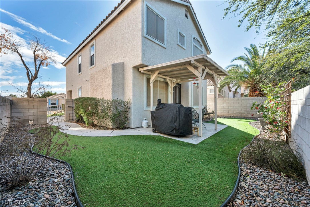 2132 Polynesia Circle Henderson, NV 89074 - Photo 22 of 25 Low-maintenance astroturf and a covered patio create the perfect outdoor space for relaxing or entertaining year-round.