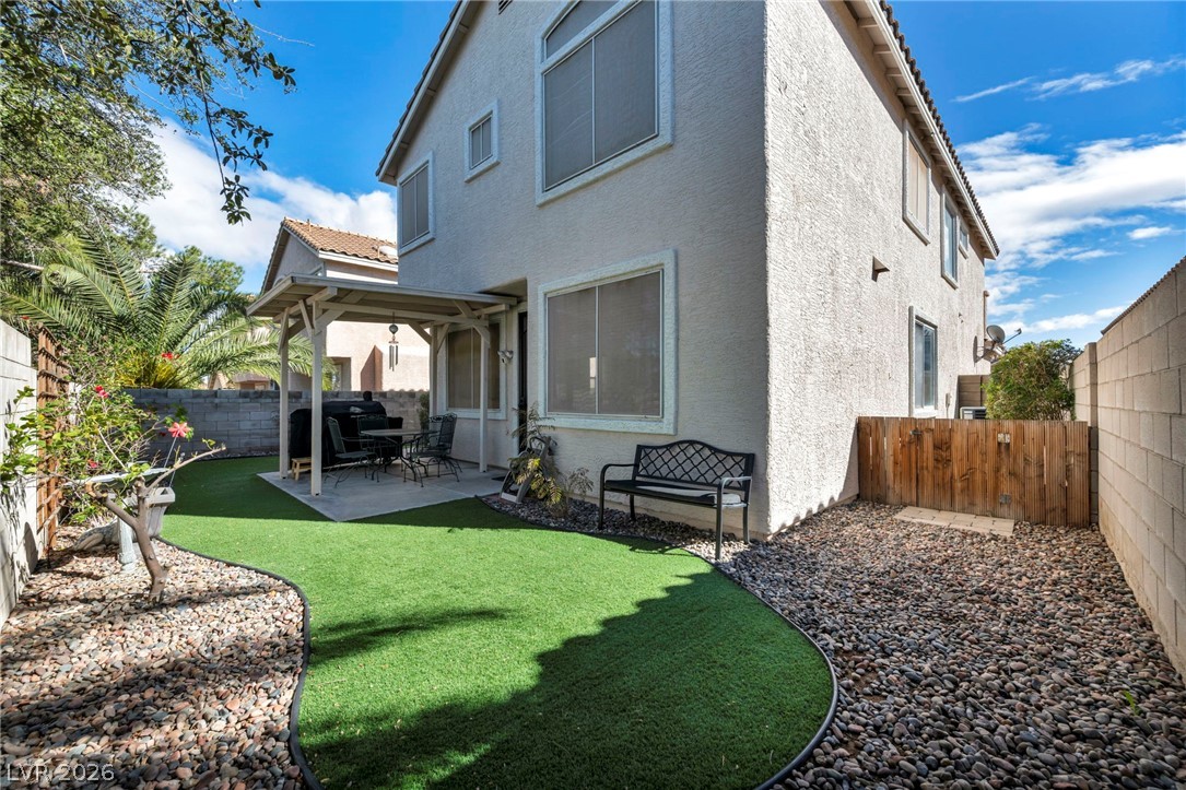 2132 Polynesia Circle Henderson, NV 89074 - Photo 24 of 25 Low-maintenance astroturf and a covered patio create the perfect outdoor space for relaxing or entertaining year-round.