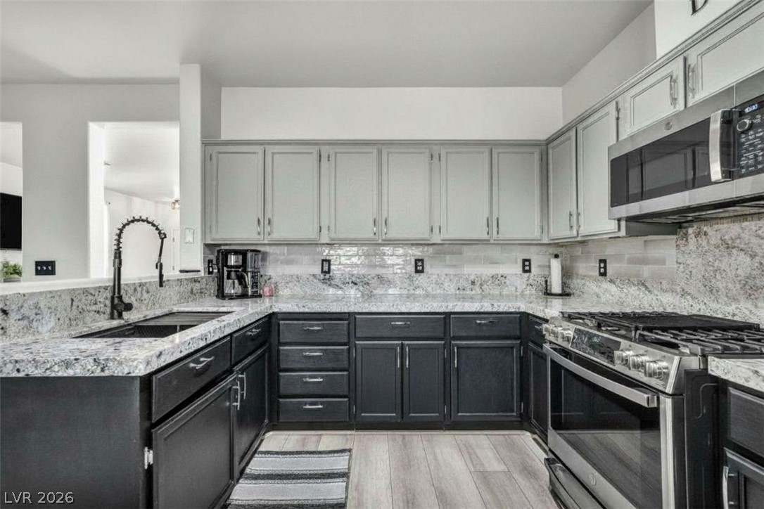 2132 Polynesia Circle Henderson, NV 89074 - Photo 7 of 25 Freshly updated with new countertops and GE Profile appliances, this kitchen blends style and function for everyday living and effortless hosting.