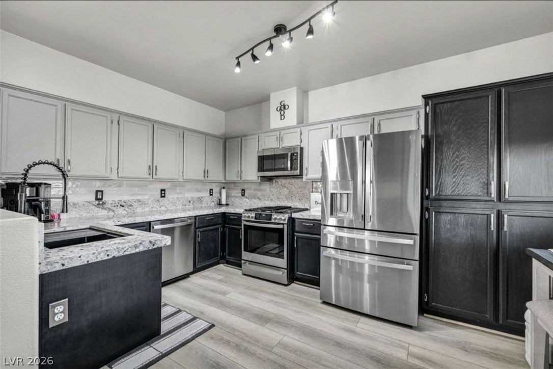 2132 Polynesia Circle Henderson, NV 89074 - Photo 8 of 25 Freshly updated with new countertops and GE Profile appliances, this kitchen blends style and function for everyday living and effortless hosting.