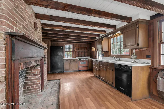 a kitchen with granite countertop a sink cabinets and stainless steel appliances