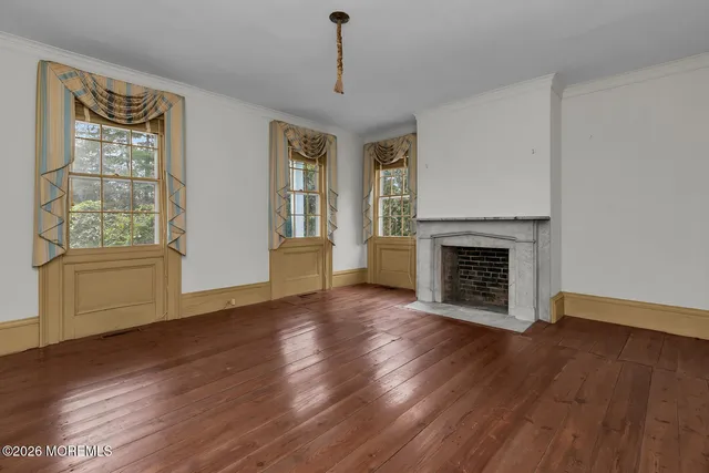 a view of a livingroom with a fireplace and window