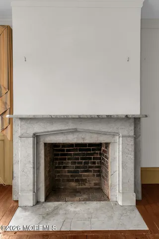 a view of an empty room and fire place