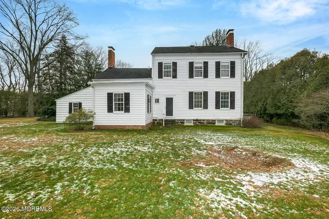 a house that has a tree in front of it
