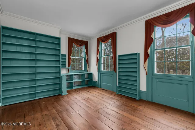 a view of empty room with cabinets and window