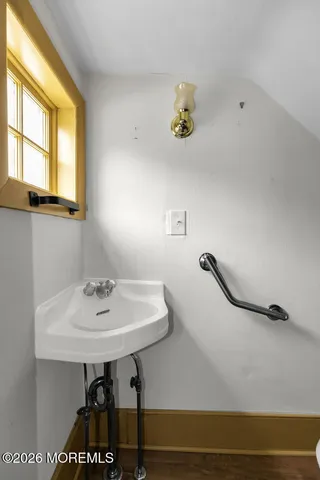 a bathroom with a sink and a window