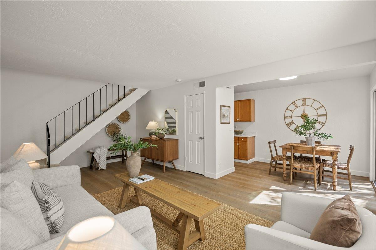 a living room with furniture and wooden floor