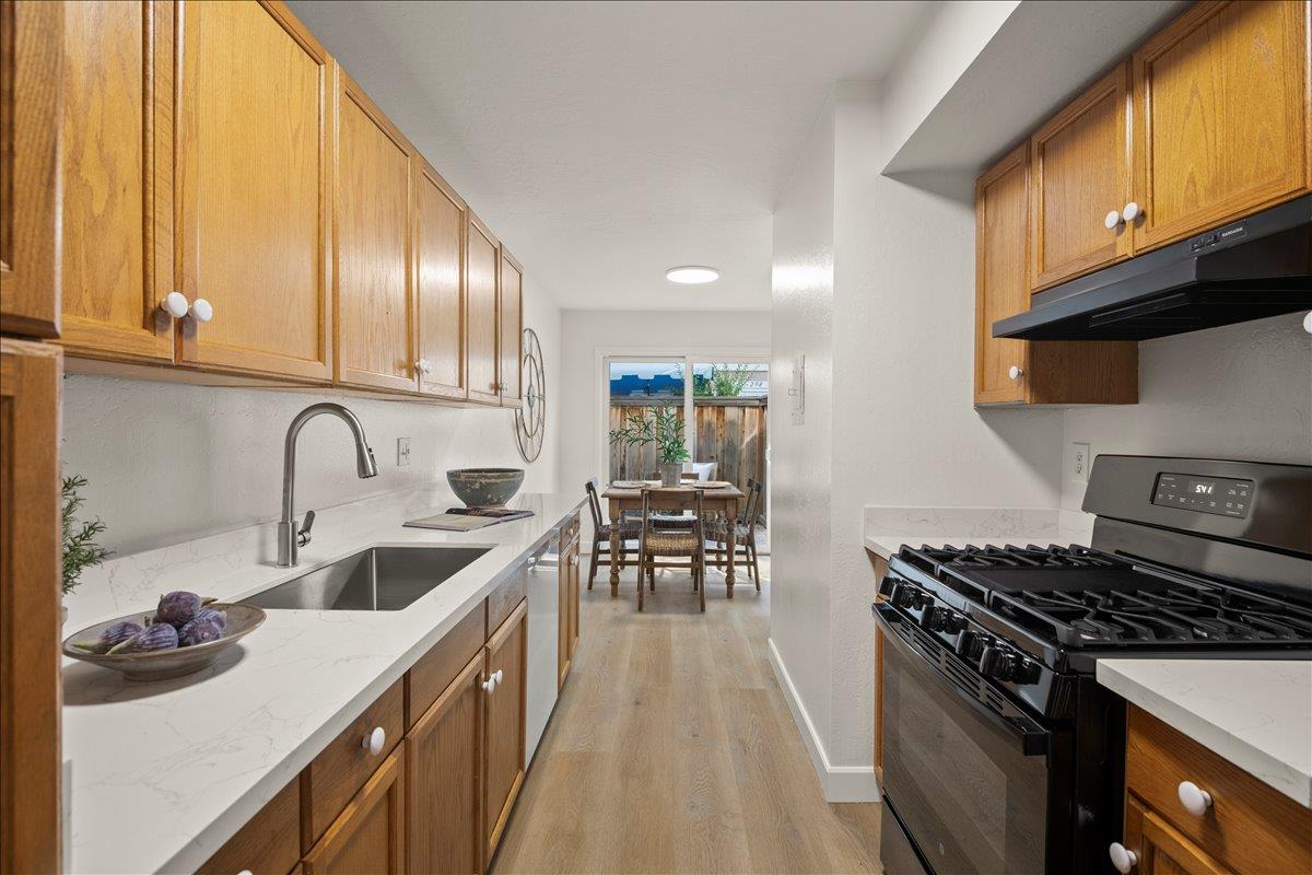 284 Rio Verde Place, Unit 3 Milpitas, CA 95035 - Photo 11 of 29 a kitchen with granite countertop a stove and a sink