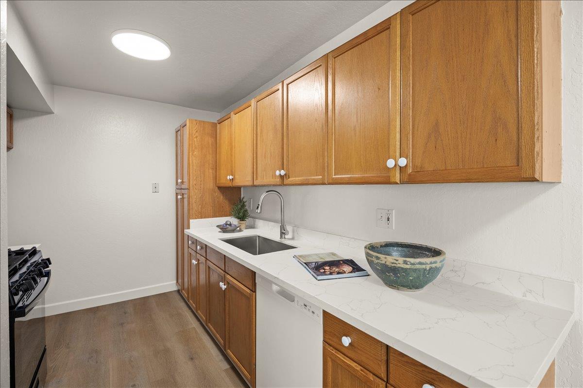 284 Rio Verde Place, Unit 3 Milpitas, CA 95035 - Photo 8 of 29 a kitchen with a sink a stove cabinets and wooden floor