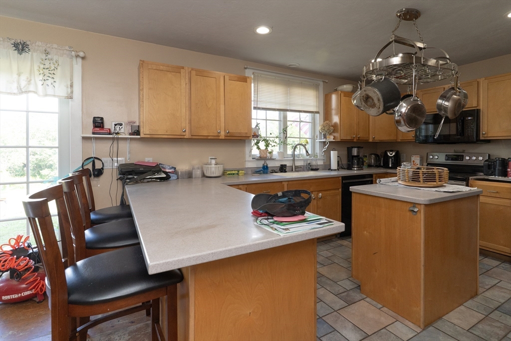157 School Street North Brookfield, MA 01535 - Photo 11 of 29 a kitchen with a table chairs sink and cabinets