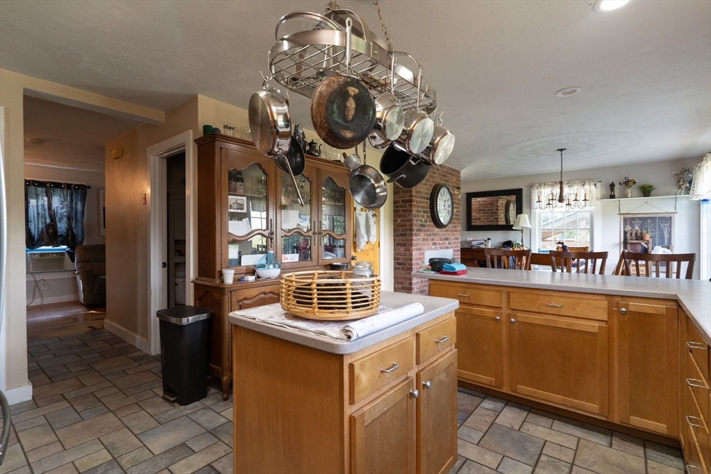 157 School Street North Brookfield, MA 01535 - Photo 13 of 29 a kitchen with a sink a stove and chairs