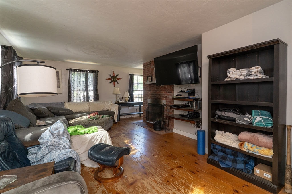 157 School Street North Brookfield, MA 01535 - Photo 18 of 29 a living room with furniture and a flat screen tv
