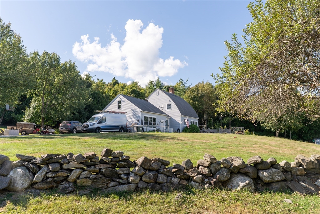157 School Street North Brookfield, MA 01535 - Photo 2 of 29 a view of a swimming pool with lawn chairs and plants