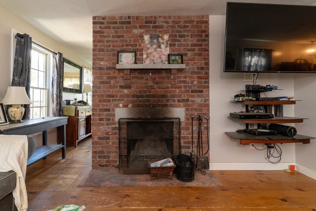157 School Street North Brookfield, MA 01535 - Photo 22 of 29 a living room with furniture a flat screen tv and a fireplace