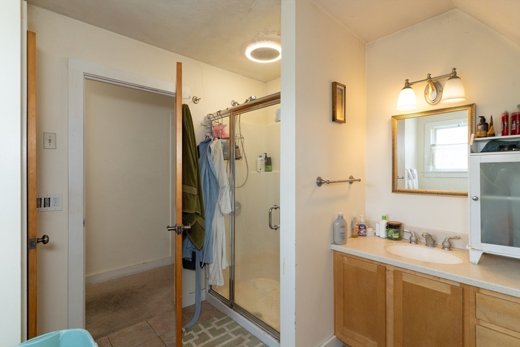 157 School Street North Brookfield, MA 01535 - Photo 23 of 29 a bathroom with a granite countertop sink mirror and shower