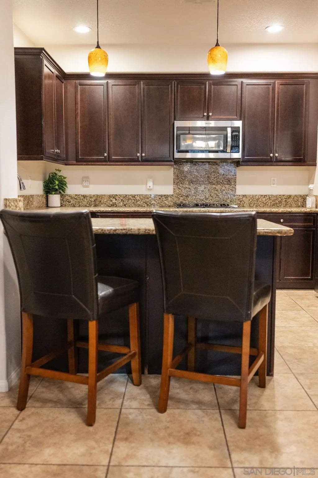 1808 Cyan Lane Chula Vista, CA 91913 - Photo 20 of 43 a kitchen with stainless steel appliances granite countertop a stove a sink and a microwave