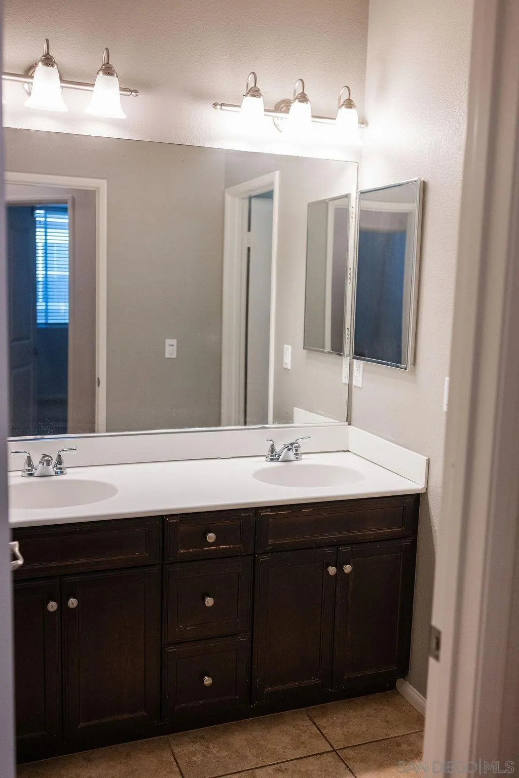 1808 Cyan Lane Chula Vista, CA 91913 - Photo 23 of 43 a bathroom with a double vanity sink and mirror