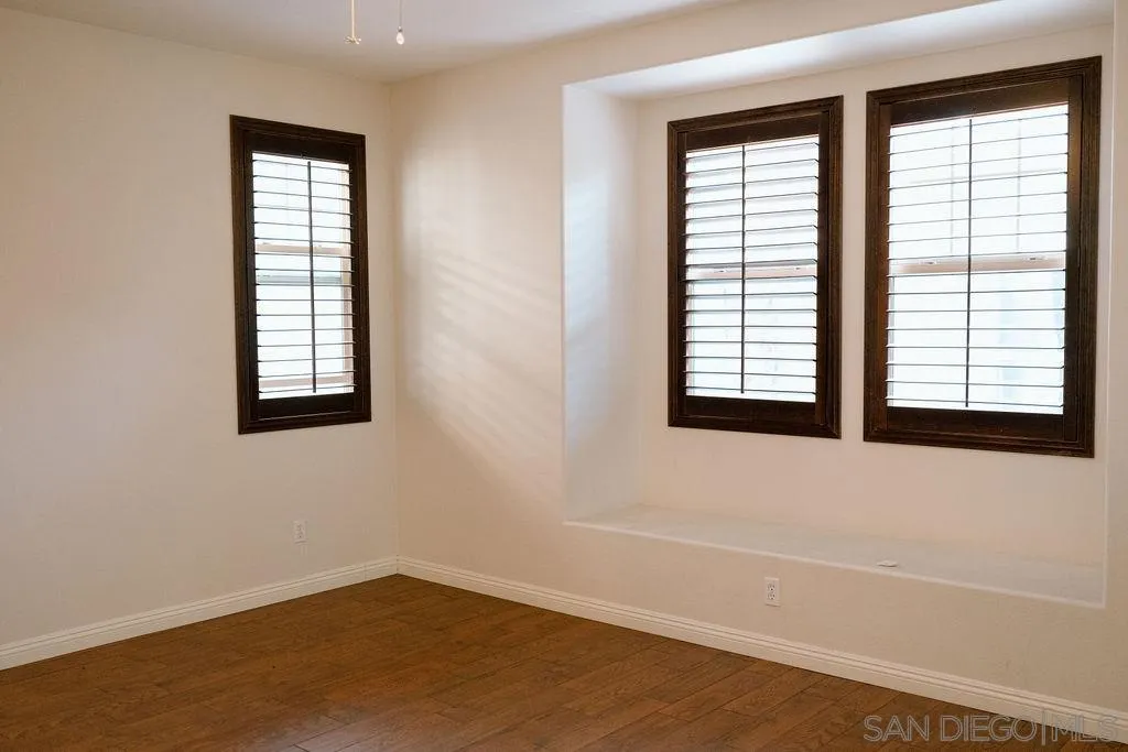 1808 Cyan Lane Chula Vista, CA 91913 - Photo 28 of 43 an empty room with wooden floor and windows