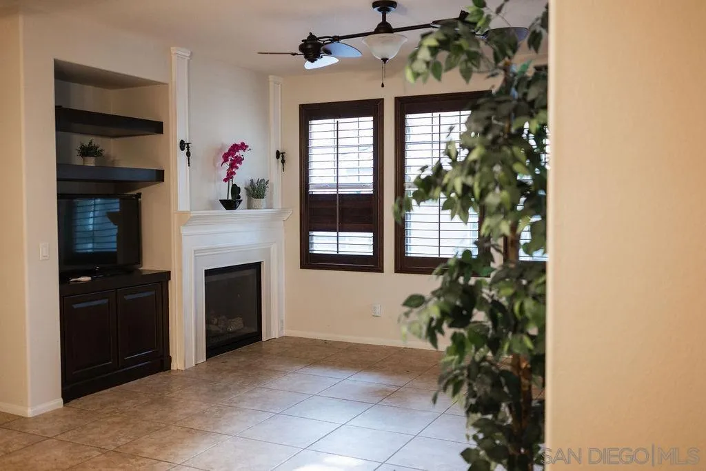 1808 Cyan Lane Chula Vista, CA 91913 - Photo 8 of 43 a living room with a potted plant and a fireplace