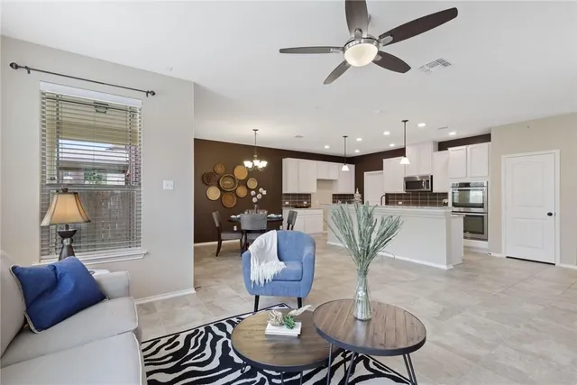 a living room with furniture potted plant and a chandelier