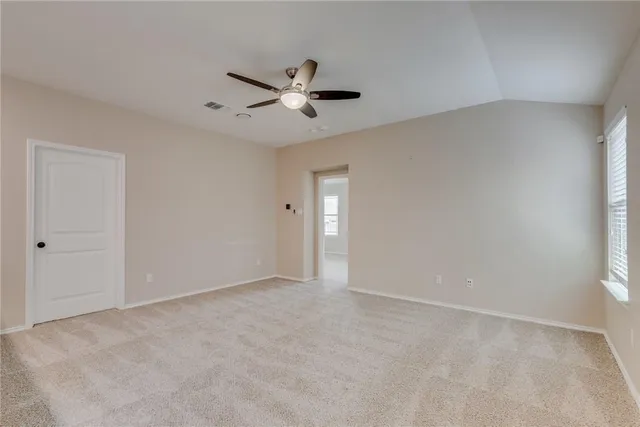 a view of staircase with railing and white walls