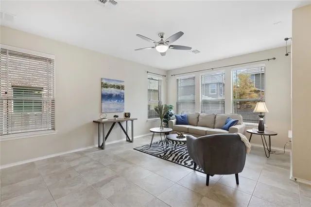 a living room with furniture a dining table and a window