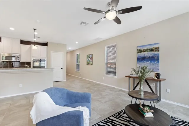 a living room with furniture a window and a table