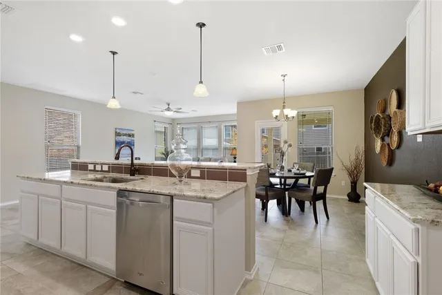 a kitchen with stainless steel appliances kitchen island granite countertop a sink and cabinets