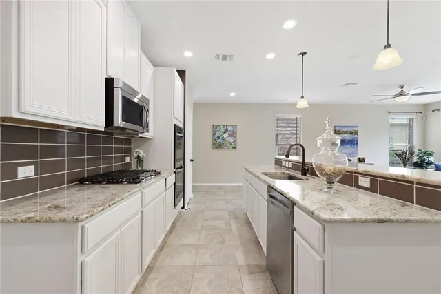 a kitchen with center island table and chairs
