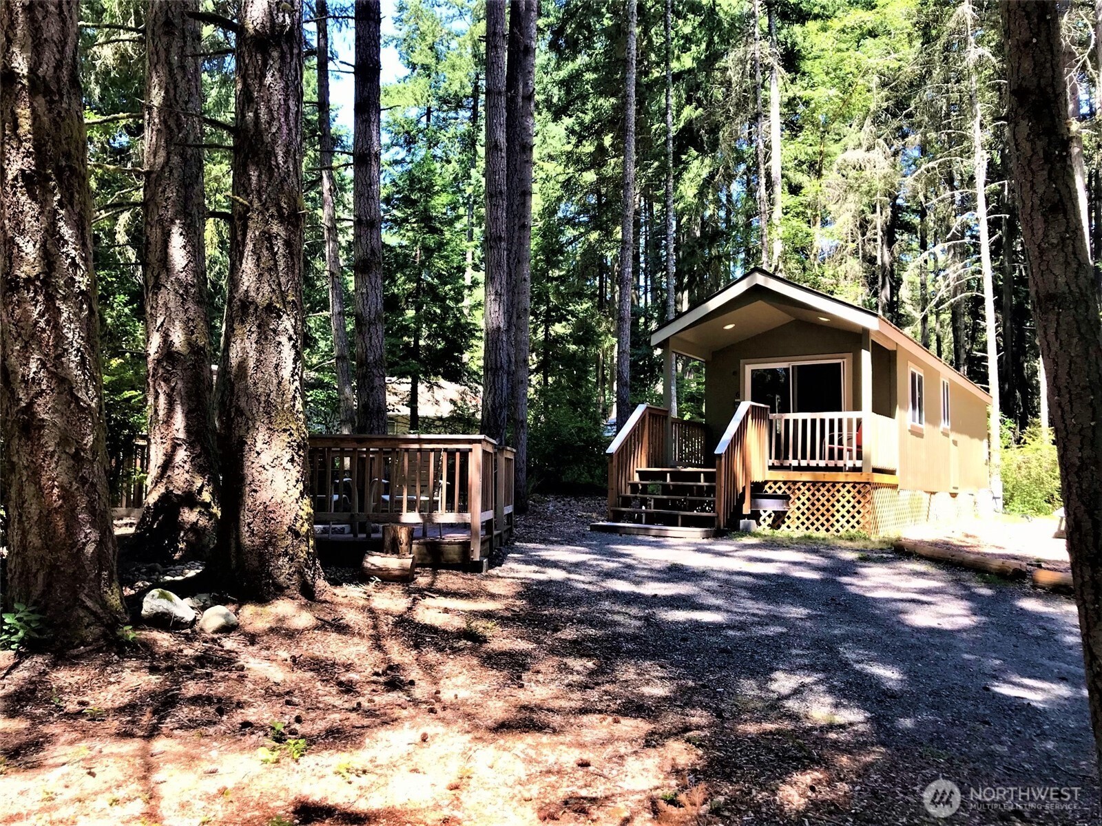 9112 Johnson Road Anderson Island, WA 98303 - Photo 11 of 16 a view of a house with a tree in the background