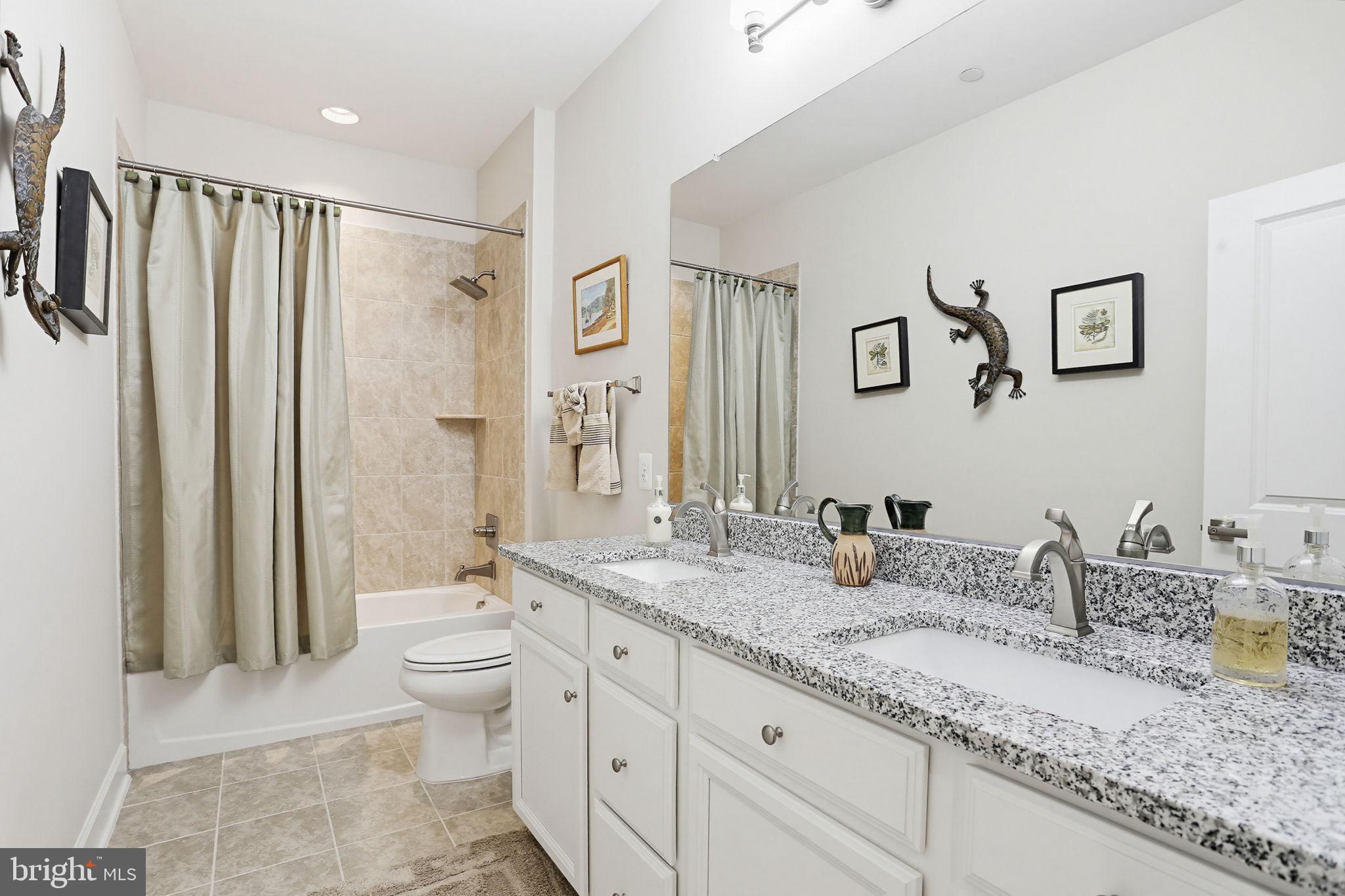 3816 Fulham Road Frederick, MD 21704 - Photo 32 of 77 a bathroom with double sink and a mirror