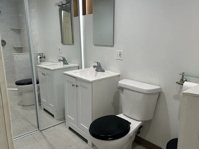 a bathroom with a toilet sink and mirror