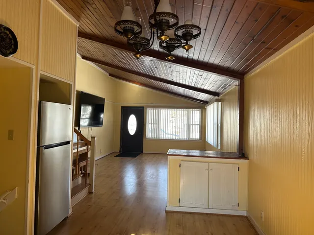 a view of a refrigerator in kitchen and wooden floor