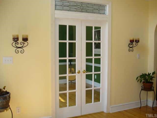 2324 Primrose Valley Court Raleigh, NC 27613 - Photo 3 of 10 Pretty French doors lead to formal living room or what could be a great office. Custom glass work transom. 2 story foyer welcomes you into this lovely home.