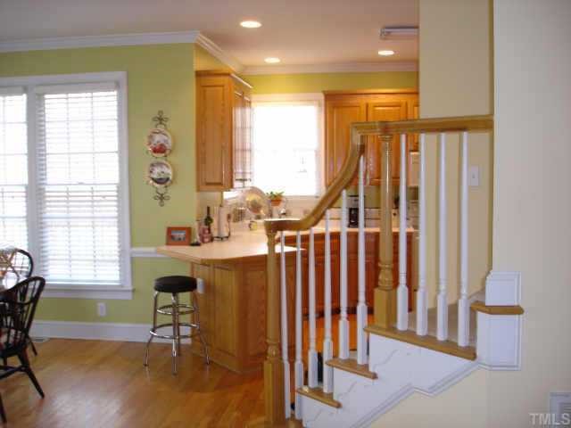 2324 Primrose Valley Court Raleigh, NC 27613 - Photo 8 of 10 View from family room looking towards pretty curved stairwell, kitchen and breakfast room.