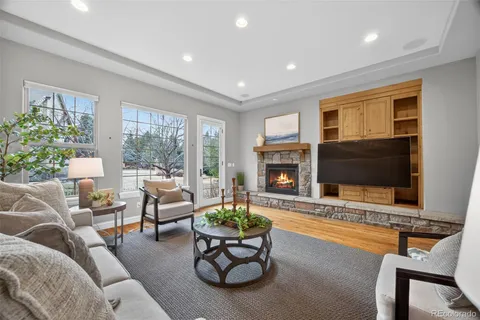 a living room with furniture a flat screen tv and a large window