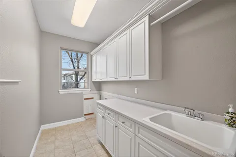 a spacious bathroom with a granite countertop sink and a bathtub