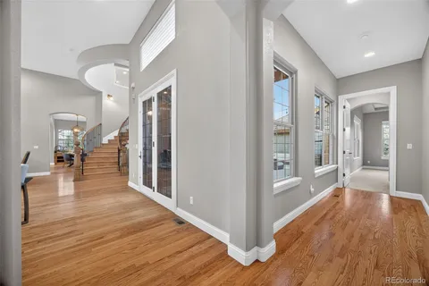a view of a hallway view with wooden floor and staircase