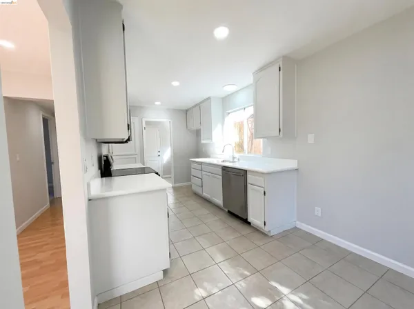 a kitchen with a sink a counter top space and stainless steel appliances
