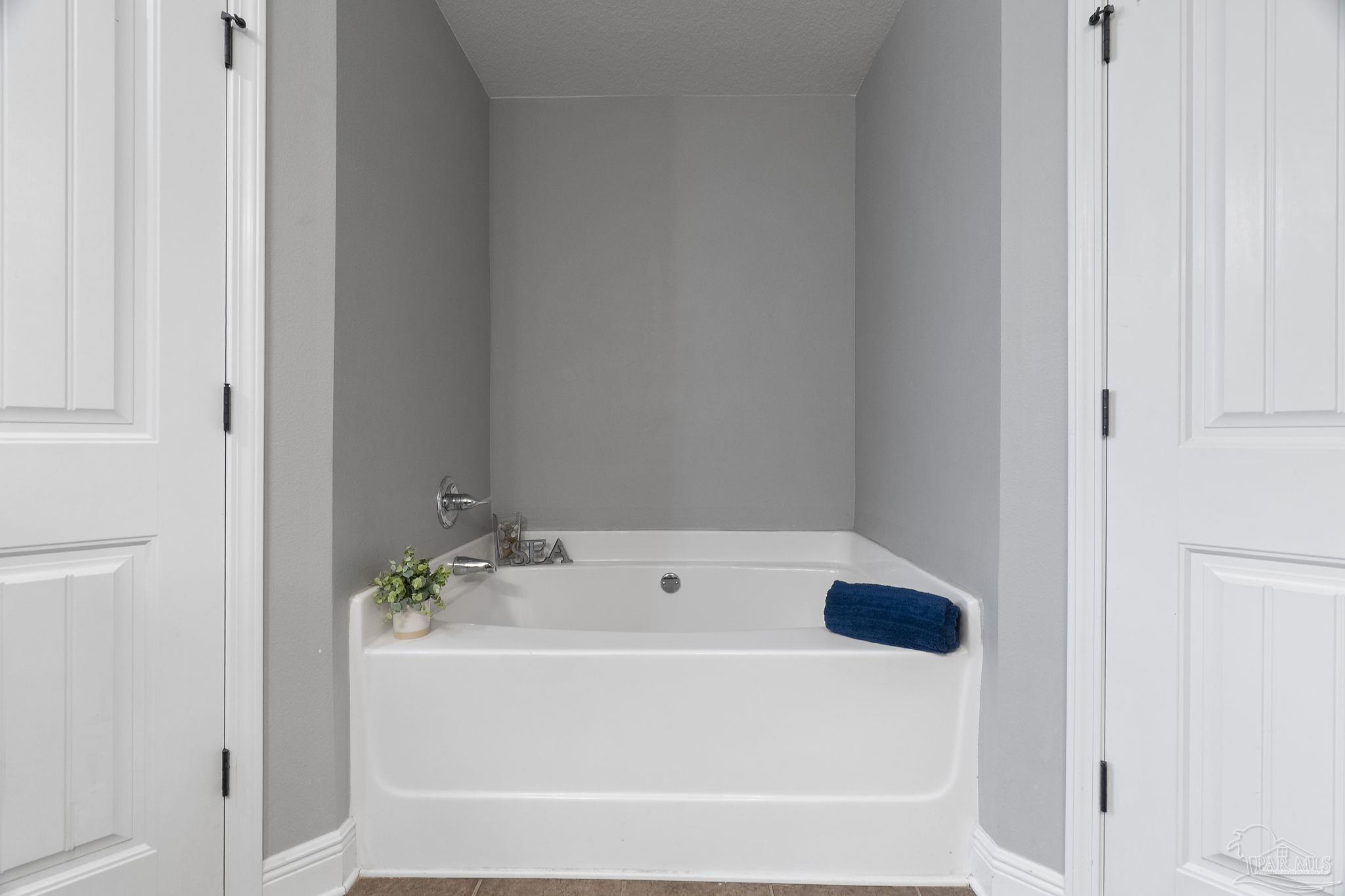 5607 Cane Syrup Circle Pace, FL 32571 - Photo 29 of 54 a bathroom with a bathtub