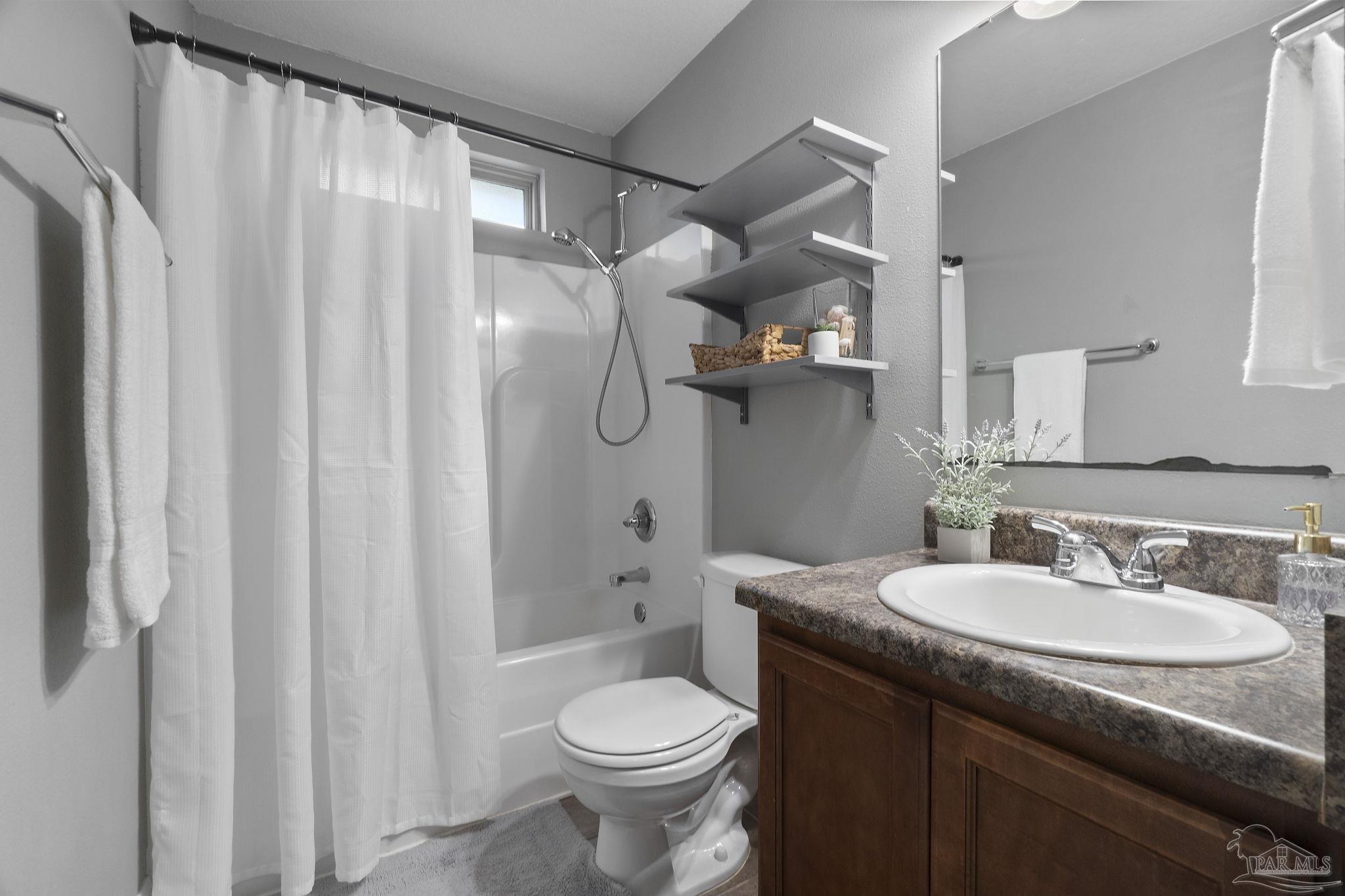5607 Cane Syrup Circle Pace, FL 32571 - Photo 37 of 54 a bathroom with a granite countertop sink toilet and shower