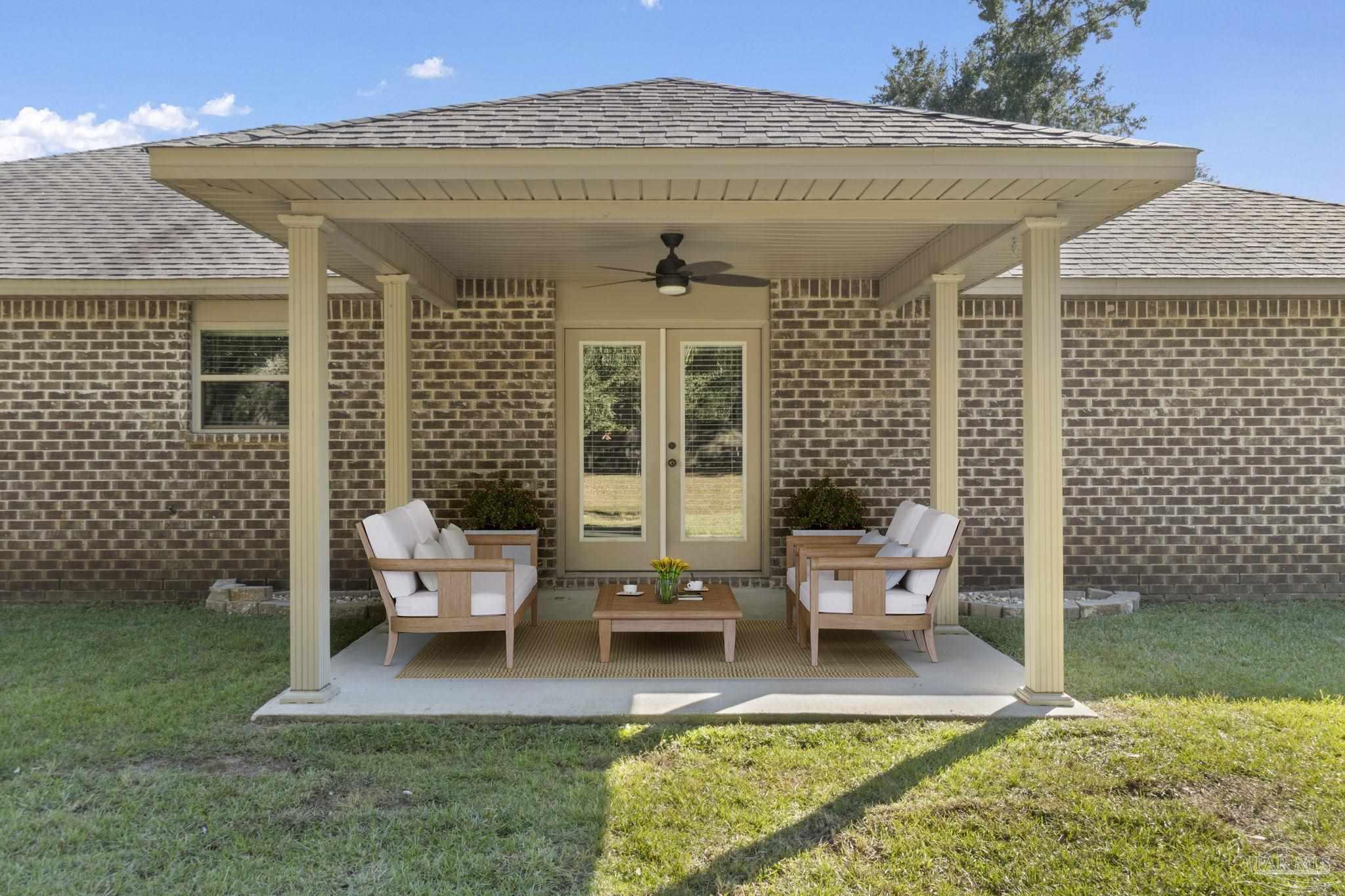 5607 Cane Syrup Circle Pace, FL 32571 - Photo 40 of 54 a view of a patio with couches chairs and potted plants