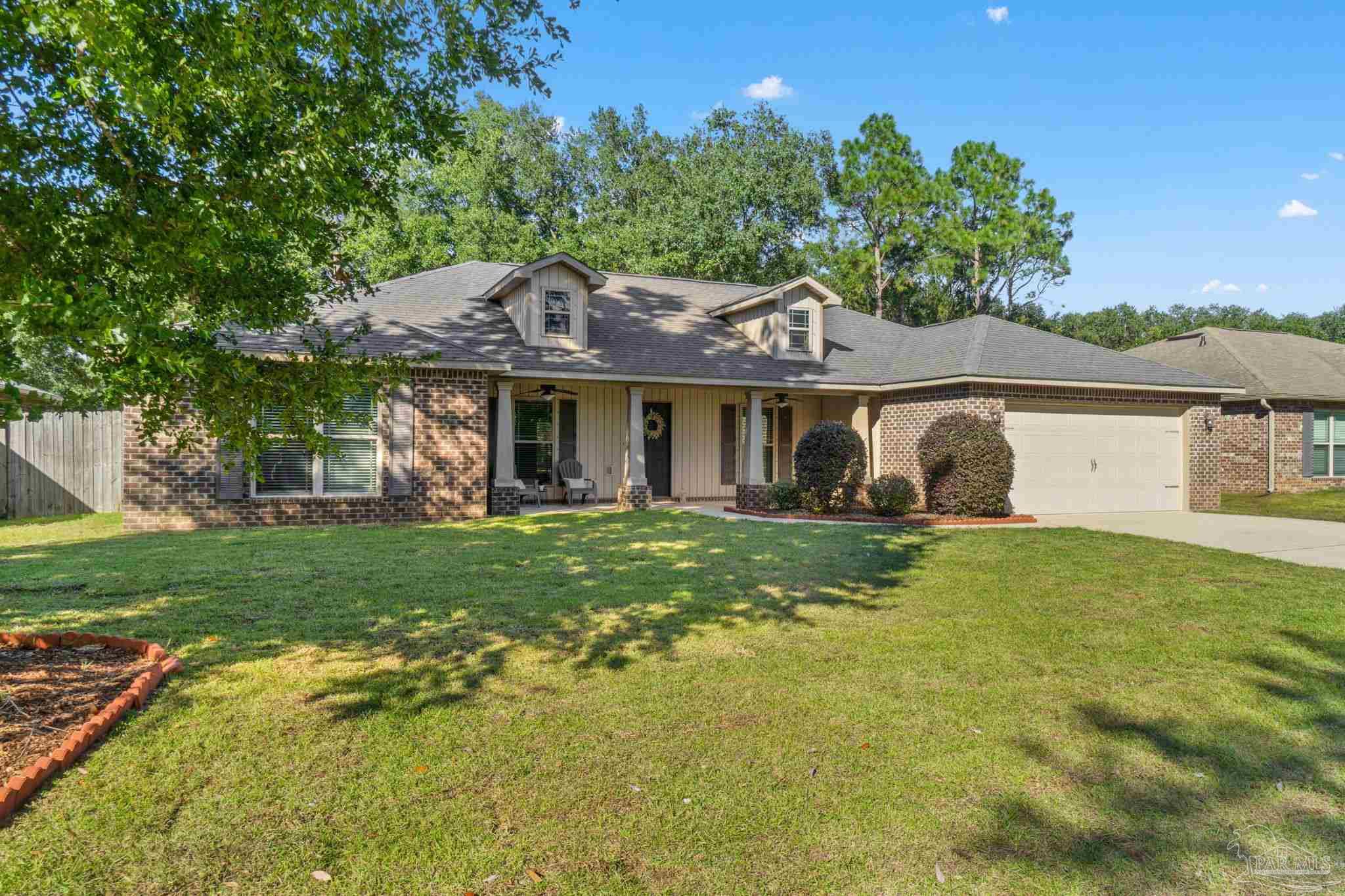 5607 Cane Syrup Circle Pace, FL 32571 - Photo 6 of 54 a front view of a house with a yard