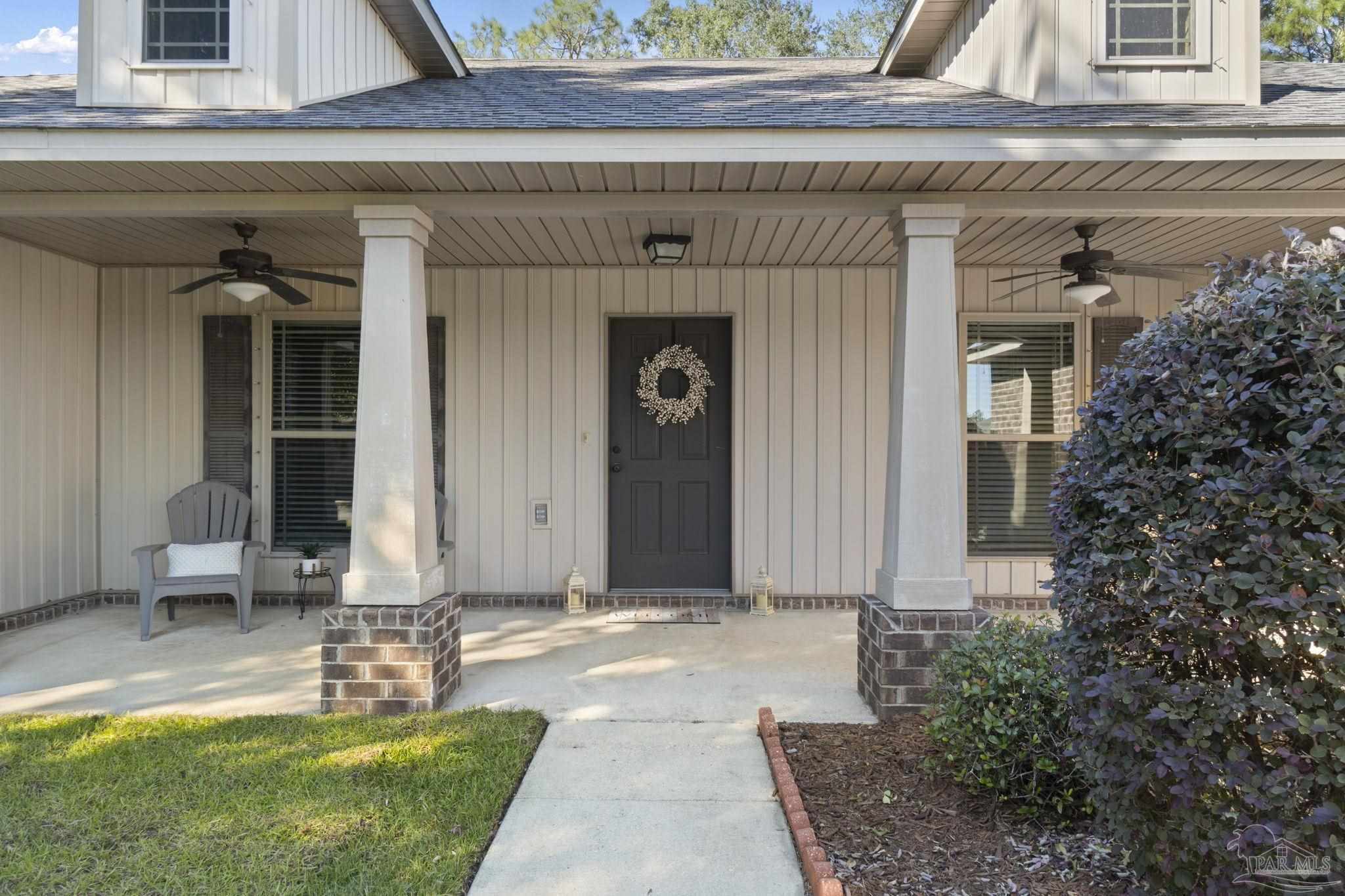 5607 Cane Syrup Circle Pace, FL 32571 - Photo 8 of 54 a front view of a house with garden